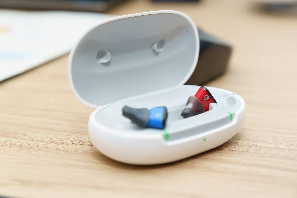 Two hearing aids in an open charging case